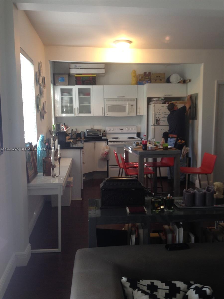577 Northeast 62nd Street, Unit 8 Miami, FL 33138 - Photo 20 of 21 a room with lots of wooden chairs a sink and a potted plant