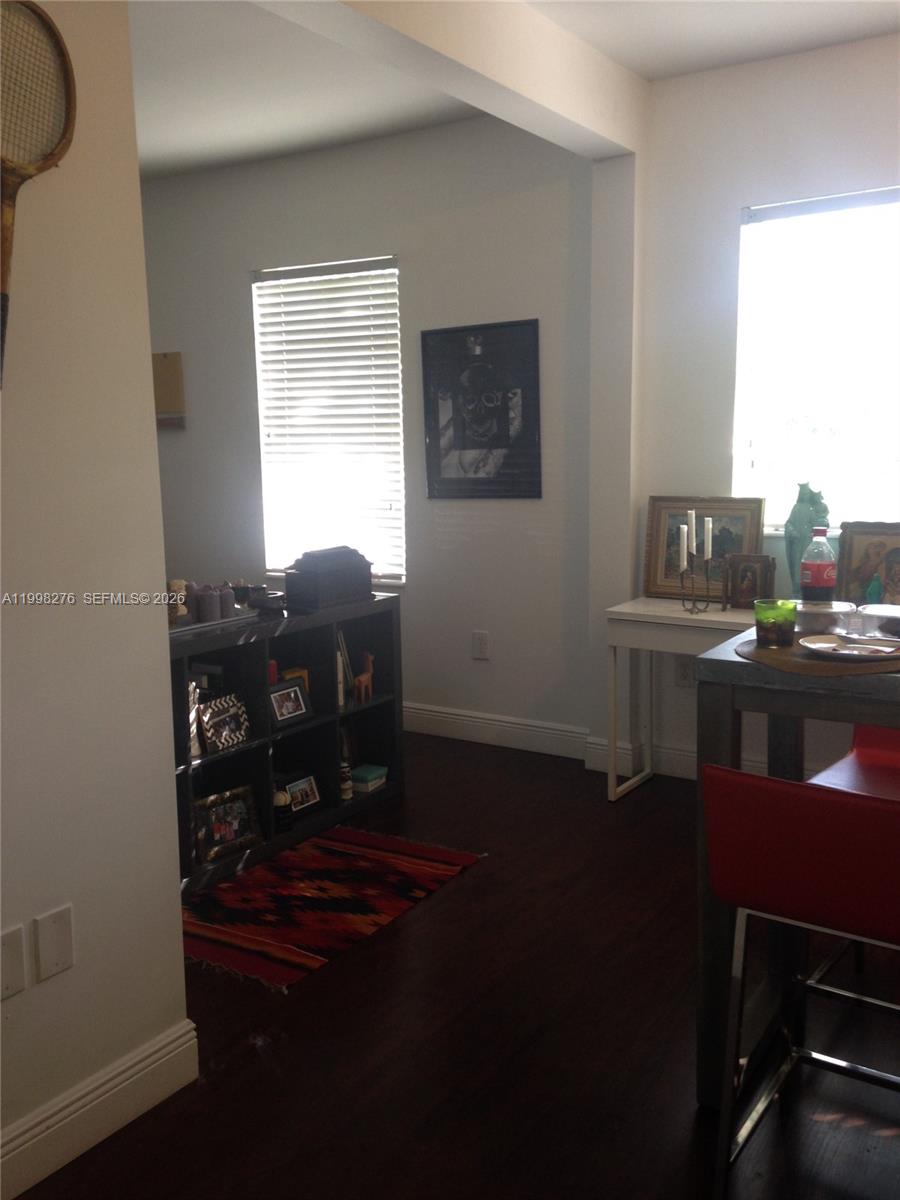 577 Northeast 62nd Street, Unit 8 Miami, FL 33138 - Photo 21 of 21 a room with a table chairs and a window