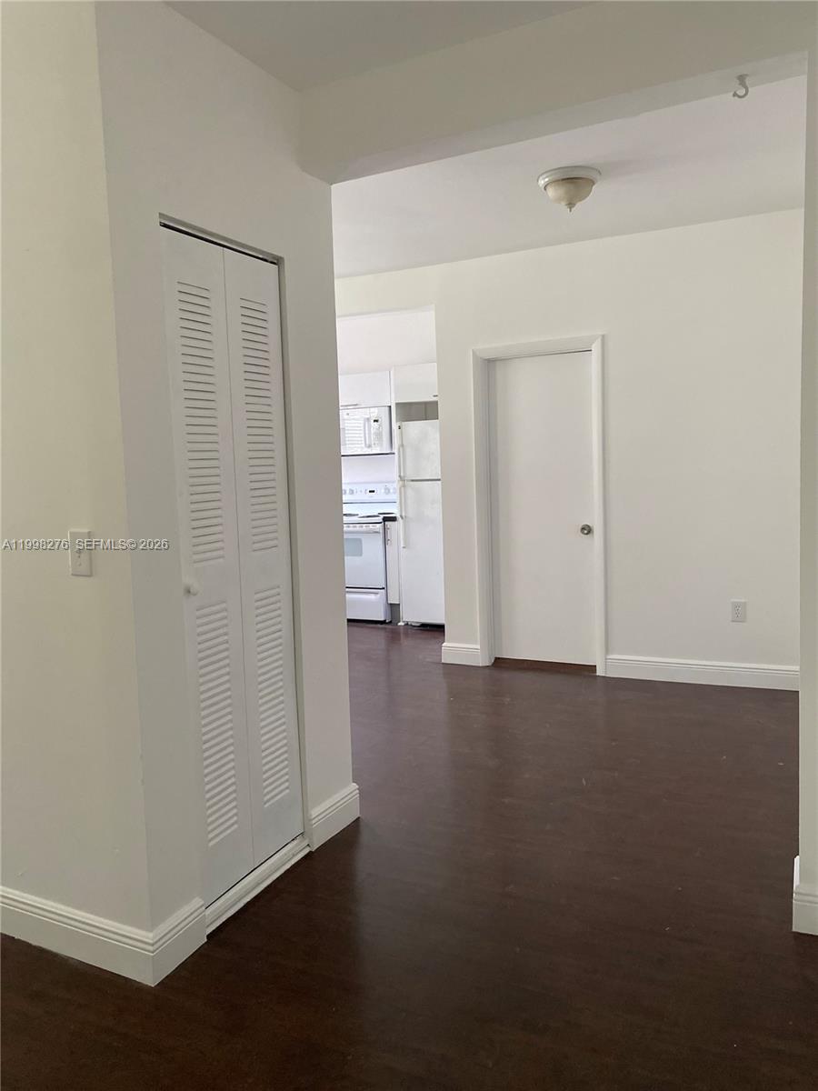 577 Northeast 62nd Street, Unit 8 Miami, FL 33138 - Photo 5 of 21 an empty room with closet and wooden floor
