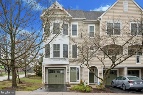 a front view of a residential apartment building with a yard