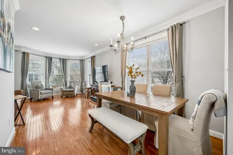 a dining room with wooden floor and a window