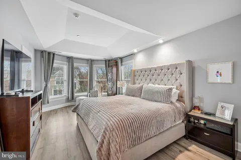 a bedroom with a large bed and a large window