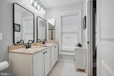 a bathroom with a double vanity sink and a mirror