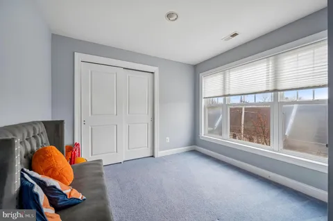 an empty room with a window and couch