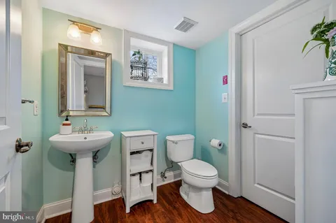 a bathroom with a toilet sink and mirror