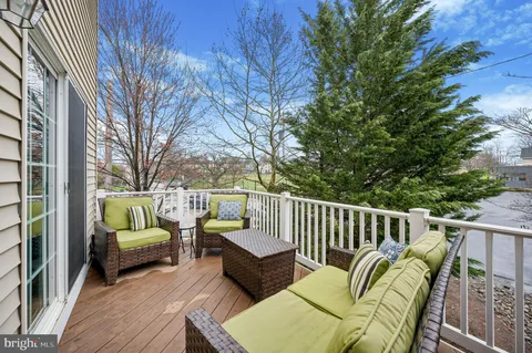 a balcony with furniture and wooden floor