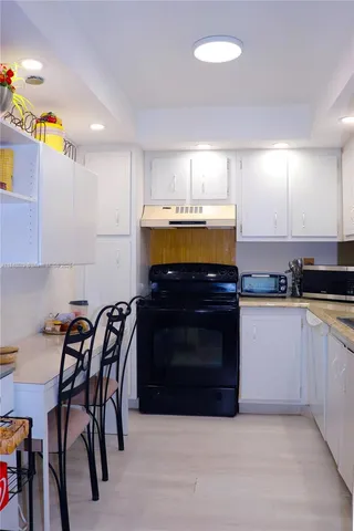 a kitchen with a refrigerator and a stove