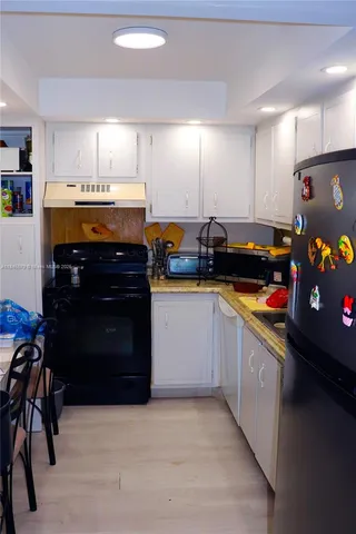 a bedroom with a bed a mirror and dresser