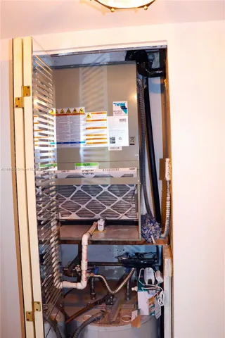 a bedroom with a bed and a closet with mirror