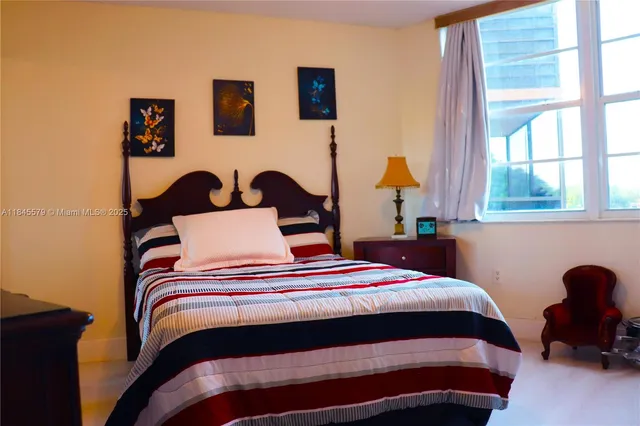 a bedroom with a bed and a potted plant