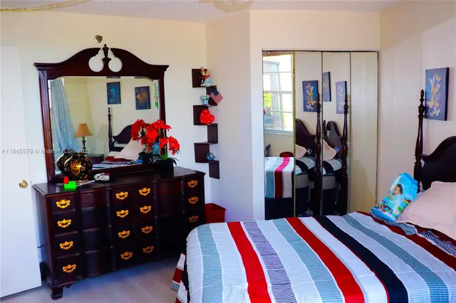 a bedroom with a bed a couch and a window