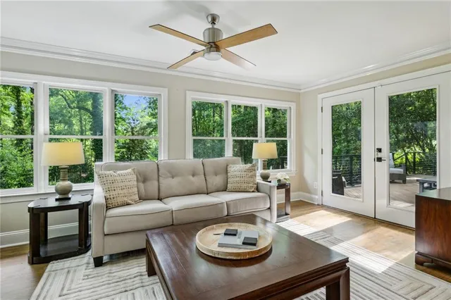 a living room with furniture a large window and a table