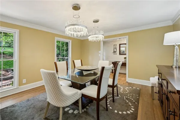 a view of a dining room with furniture window and wooden floor