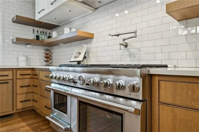 a kitchen with stainless steel appliances granite countertop a stove and a refrigerator