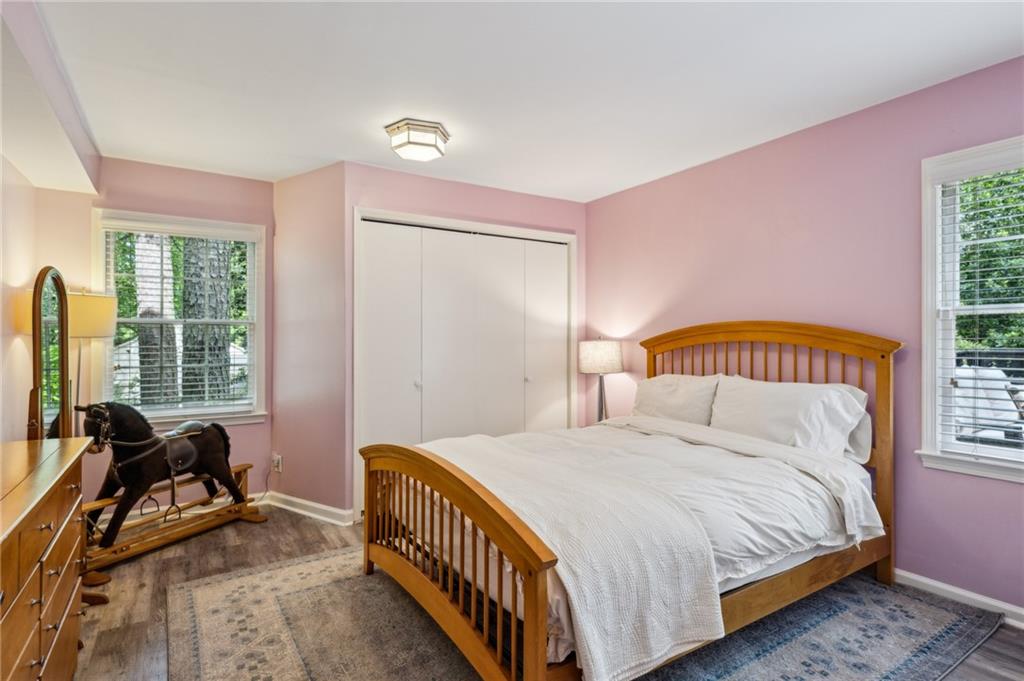 1130 Angelo Court Northeast Atlanta, GA 30319 - Photo 25 of 38 a bedroom with a bed a table and a dresser next to a window