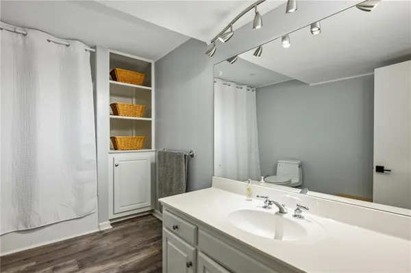 a bathroom with a sink mirror and shower