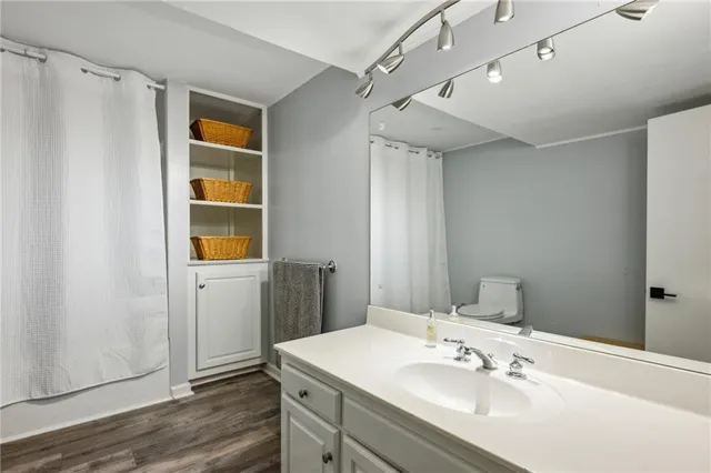 a bathroom with a sink mirror and shower