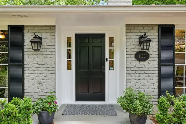 a front view of a house with a potted plant and garage
