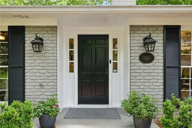 a front view of a house with a potted plant and garage