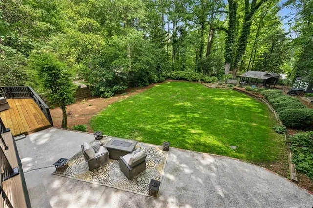 a view of a backyard with sitting area