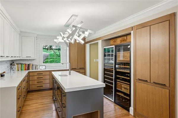 a kitchen with kitchen island a sink appliances and cabinets