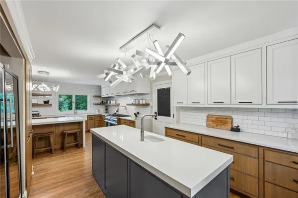 a kitchen with a sink a counter top space and appliances in it