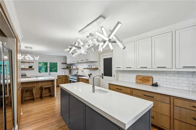 a kitchen with a sink a counter top space and appliances in it
