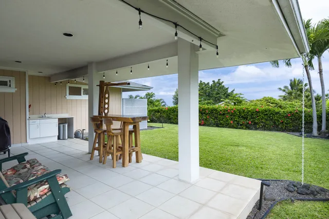 a front view of a house with garden and patio
