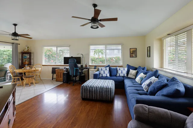 a living room with furniture flat screen tv and window