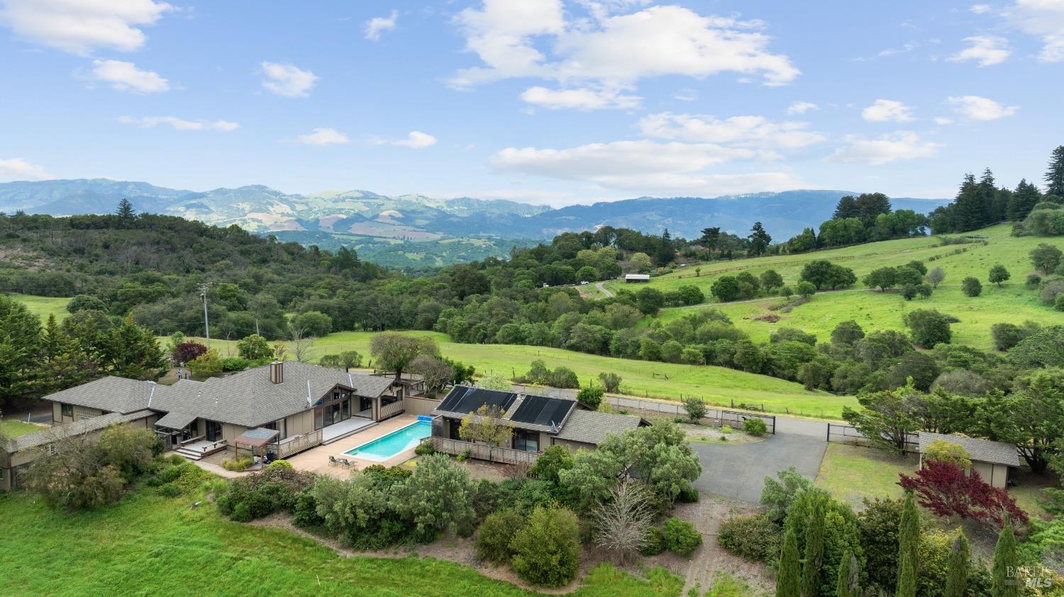 an aerial view of a house with mountain view