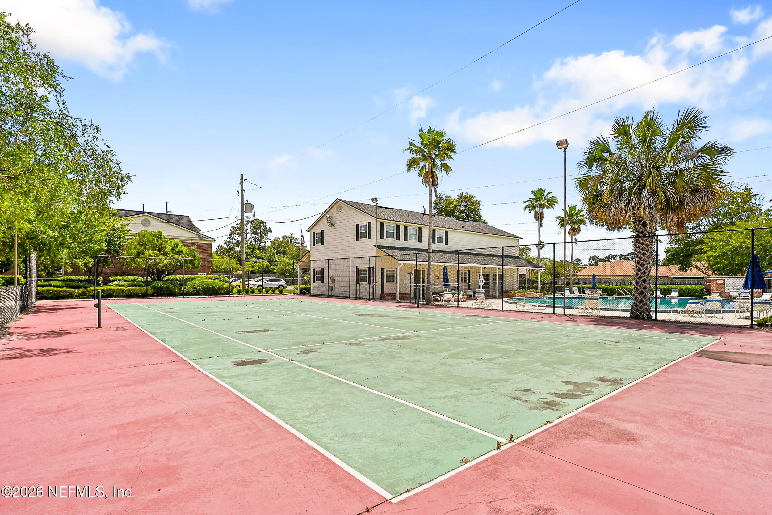 4915 Baymeadows Road, Unit 6G Jacksonville, FL 32217 - Photo 42 of 44 a view of a tennis ground with large trees