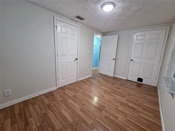 a view of a room with wooden floor and natural light