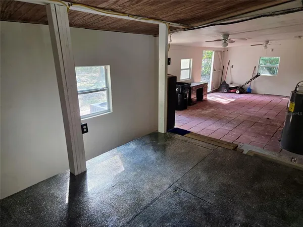a bedroom with a bed dresser and a window