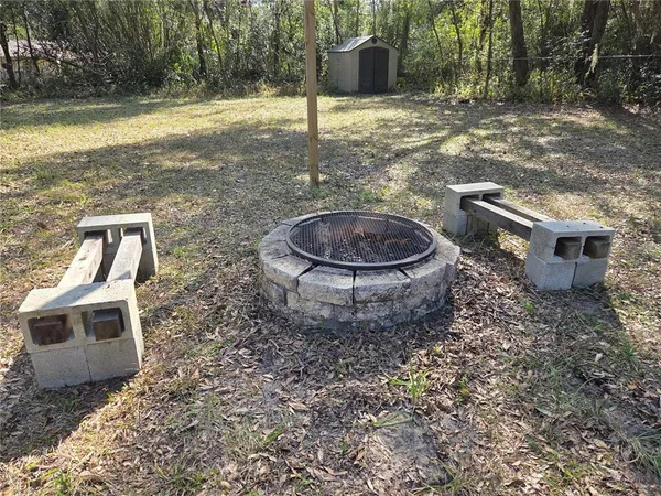 a backyard of a house with barbeque oven