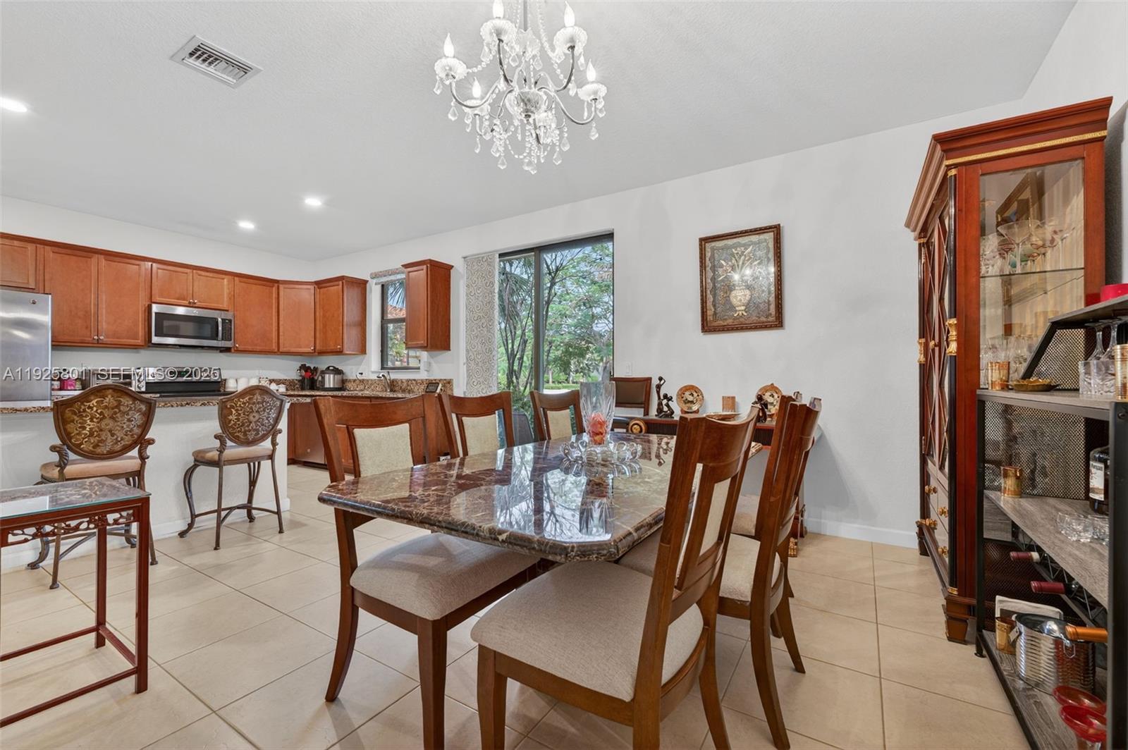 6978 Broadland Way Pompano Beach, FL 33073 - Photo 11 of 56 a view of a dining room with furniture window and outside view