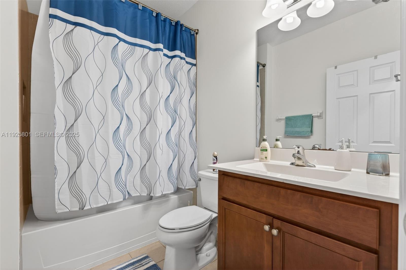 6978 Broadland Way Pompano Beach, FL 33073 - Photo 18 of 56 a bathroom with a sink vanity mirror and toilet