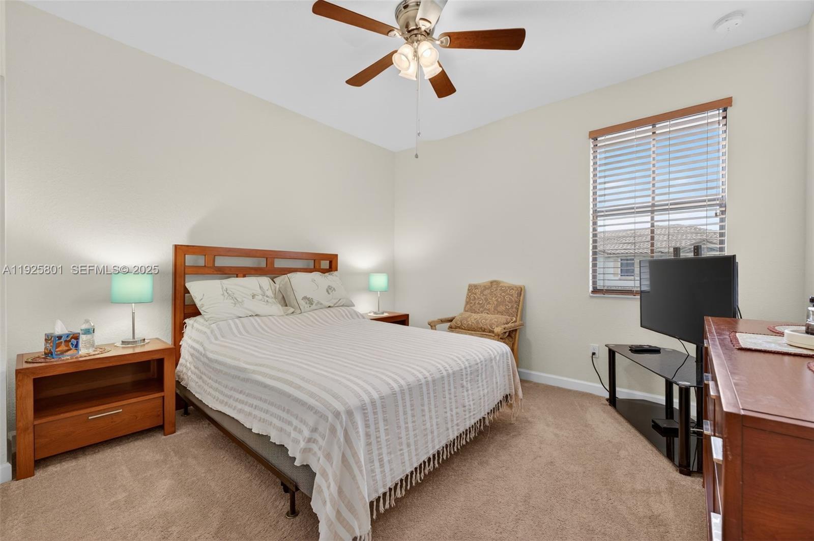 6978 Broadland Way Pompano Beach, FL 33073 - Photo 19 of 56 a bedroom with a bed and a chandelier