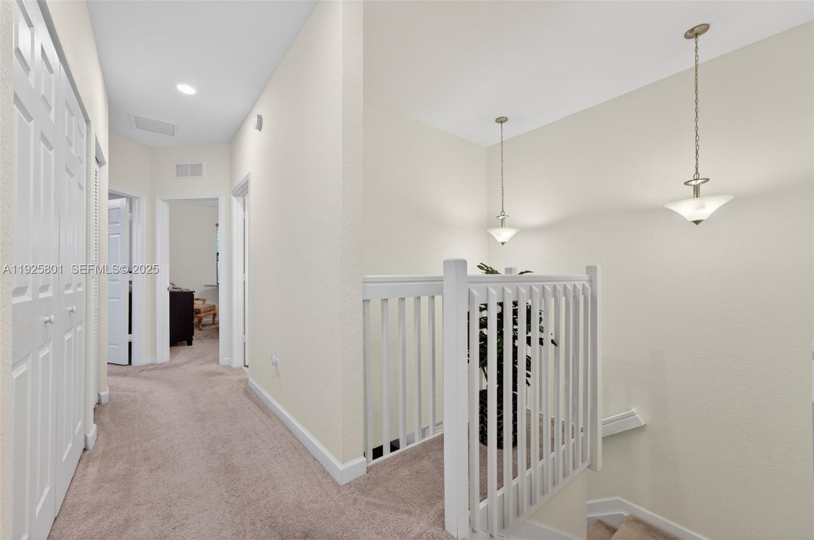6978 Broadland Way Pompano Beach, FL 33073 - Photo 23 of 56 a view of a hallway with chandelier