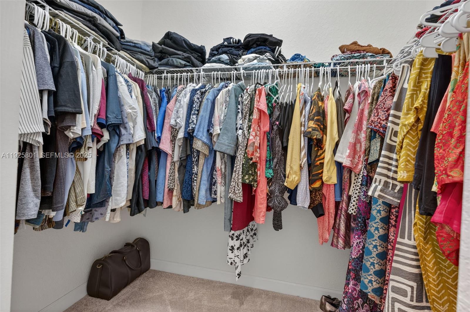 6978 Broadland Way Pompano Beach, FL 33073 - Photo 30 of 56 a view of walk in closet with clothes