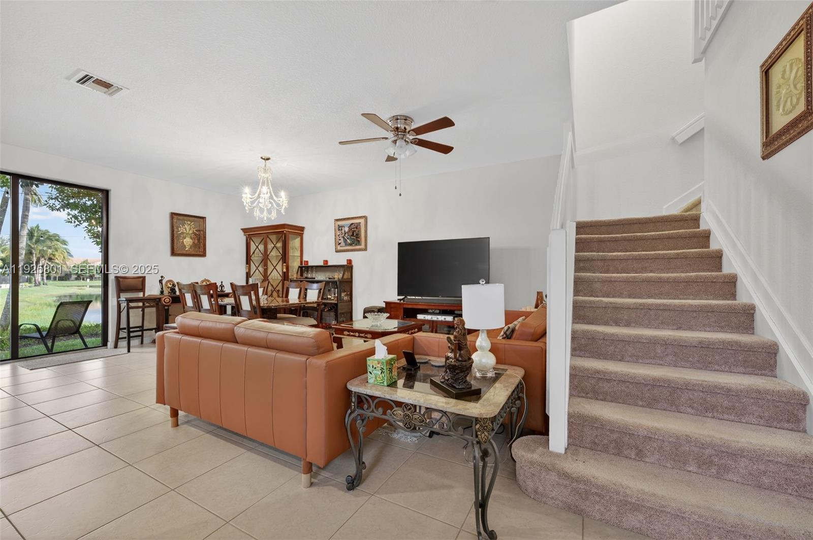 6978 Broadland Way Pompano Beach, FL 33073 - Photo 7 of 56 a living room with furniture and a flat screen tv