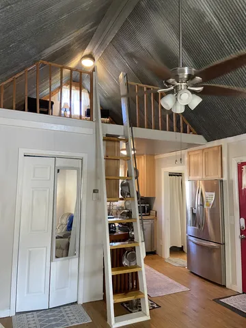 a kitchen with a sink appliances cabinets and a window