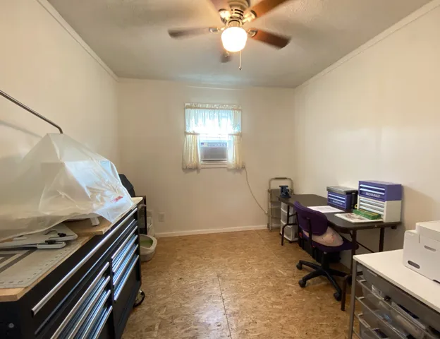 a bedroom with bed and a chandelier