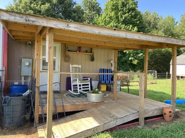 a view of a house with backyard outdoor seating and lake view