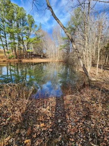 a view of residential house with outdoor space and lake view