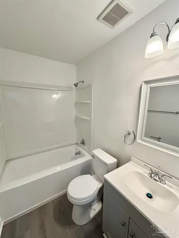 a bathroom with a sink toilet vanity and bathtub