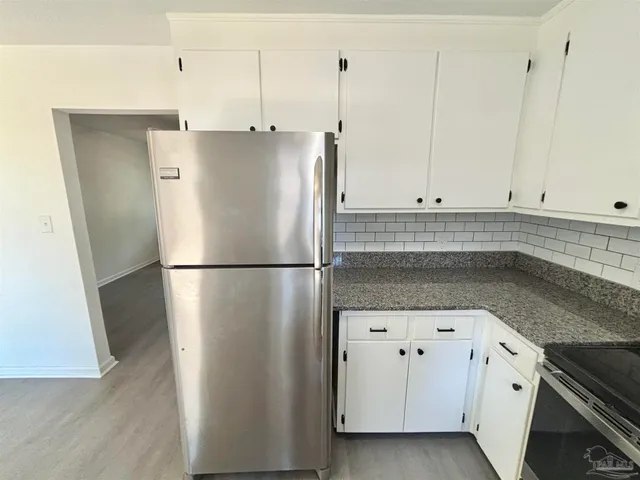 a white refrigerator freezer sitting inside of a kitchen