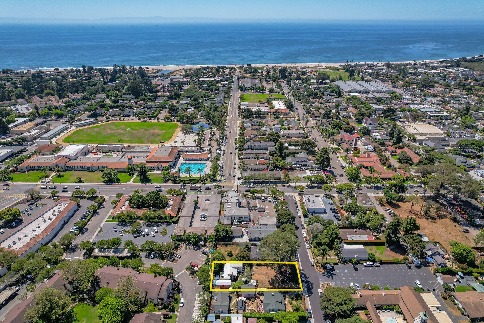 an aerial view of residential building and lake