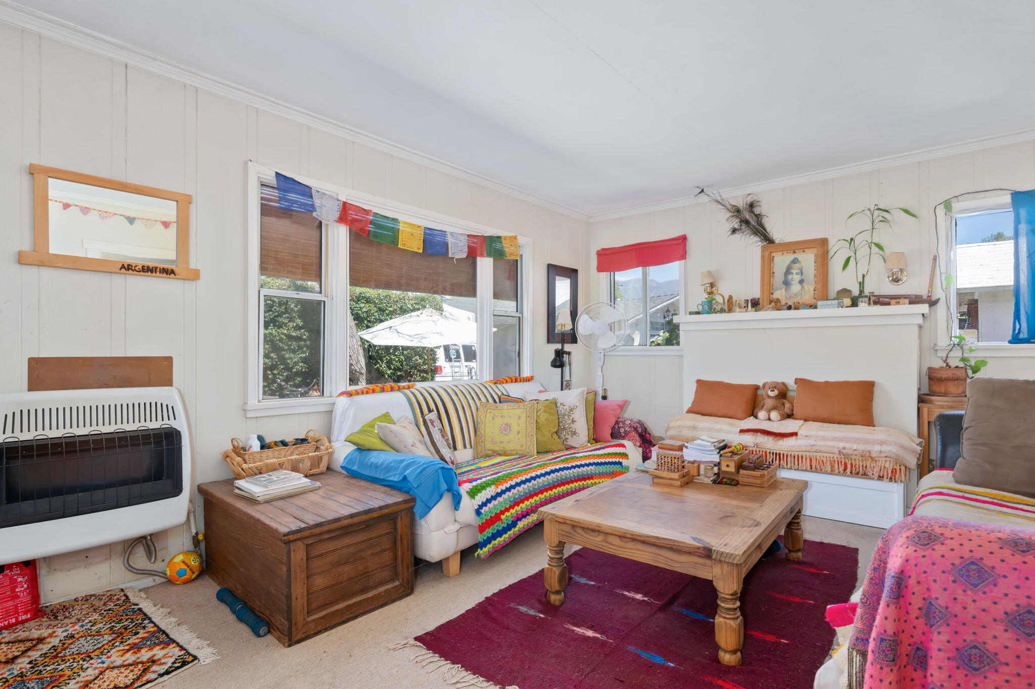 1090 Vallecito Road Carpinteria, CA 93013 - Photo 11 of 24 a living room with furniture fireplace and a large window