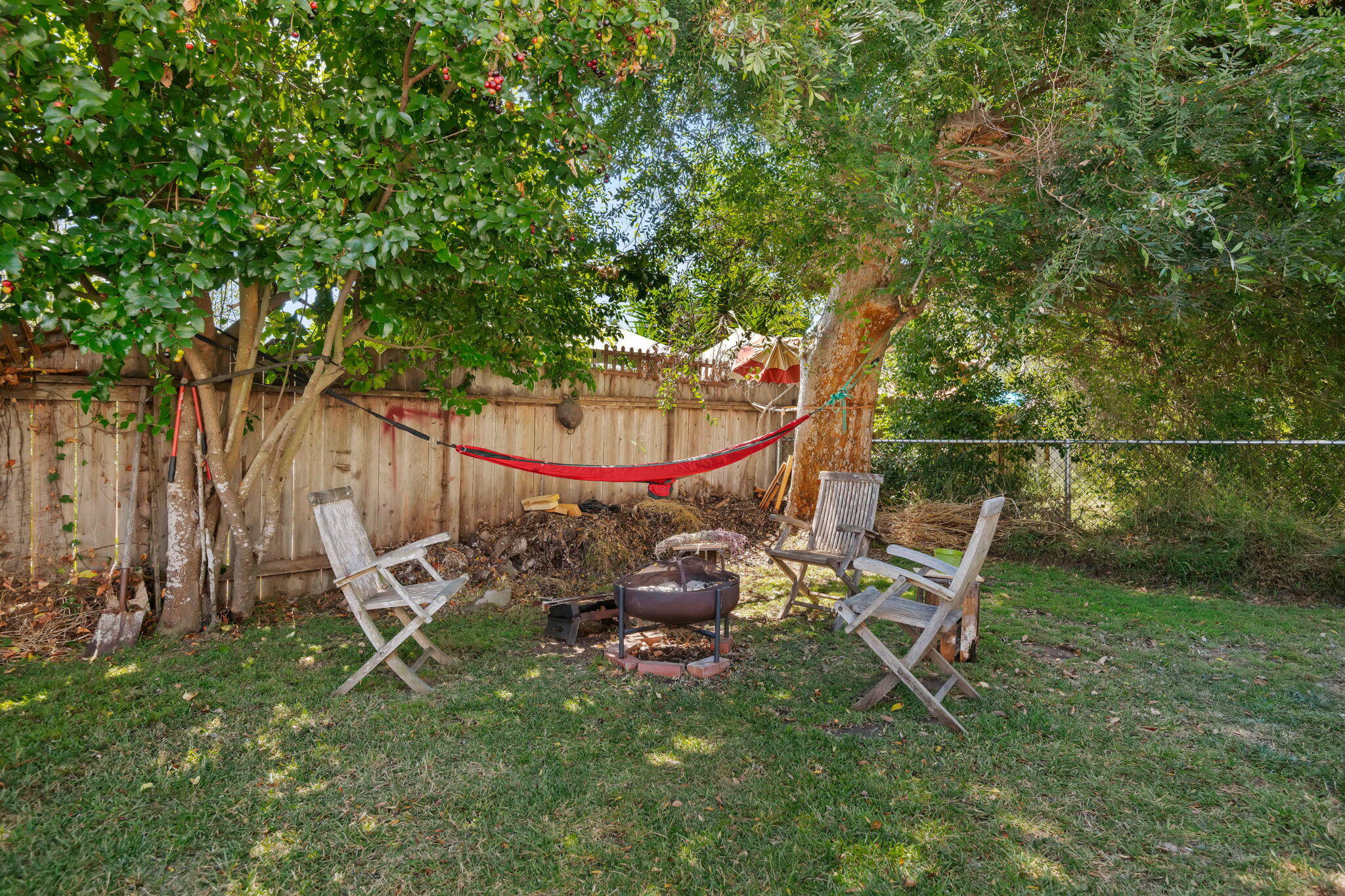 1090 Vallecito Road Carpinteria, CA 93013 - Photo 22 of 24 a backyard of a house with table and chairs