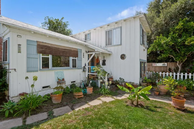 a view of a house with potted plants